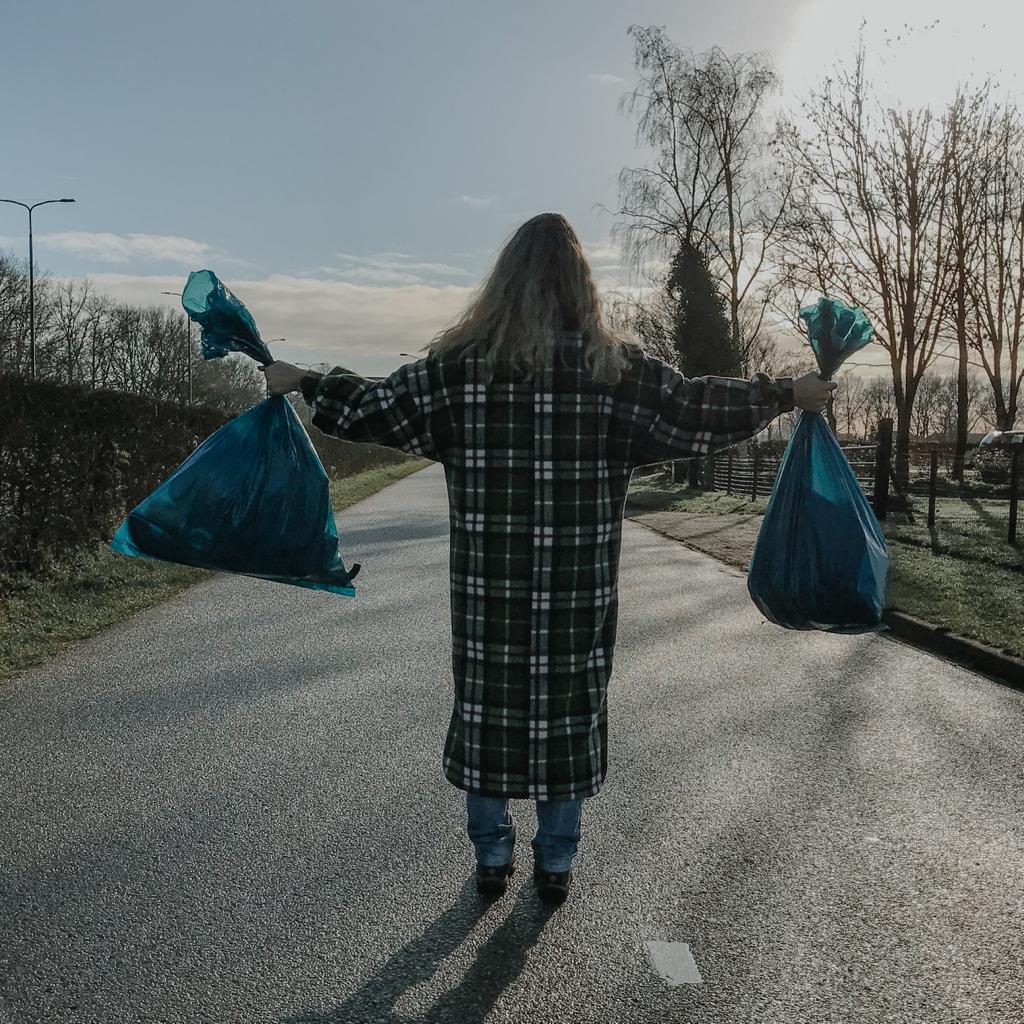 Vrouw met 2 vuilniszakken 
